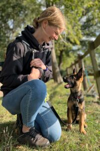 Photograph of Lisa of Nimbus Dogs, dog and puppy training with a German Shepherd police puppy