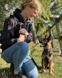 Photograph of Lisa of Nimbus Dogs, dog and puppy training with a German Shepherd police puppy